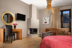 karpenisi-forest-suites-red-juior-suite-bedroom-fireplace-desk-view